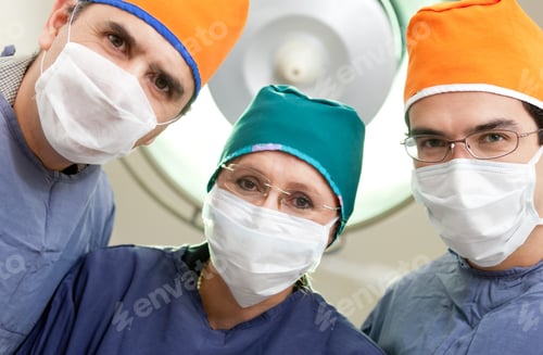 Preview: Group Of Surgeons At An Operating Room Wearing Facemasks And Hats