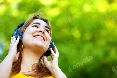Preview: Beautiful Woman With Earphones Listening To Music Outdoors