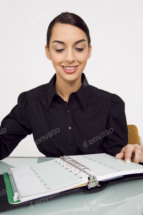Preview: Businesswoman Looking In Her Planner.