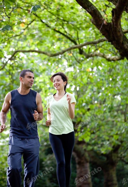 Preview: Happy Couple Jogging At The Park - Fitness Concepts