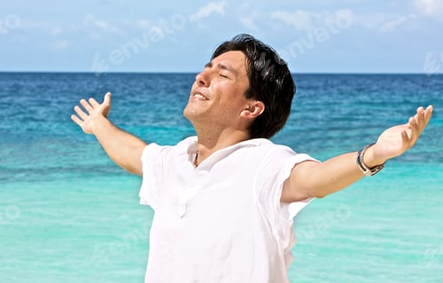 Preview: Man At The Beach With His Arms Open Enjoying His Freedom While On Vacation