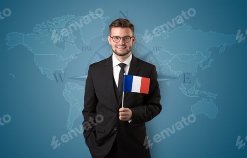 Preview: Cheerful Businessman Standing In Front Of A Map With Flag On His Hand
