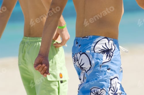 Preview: Two Guys Walking Down The Beach In A Tropical Location.