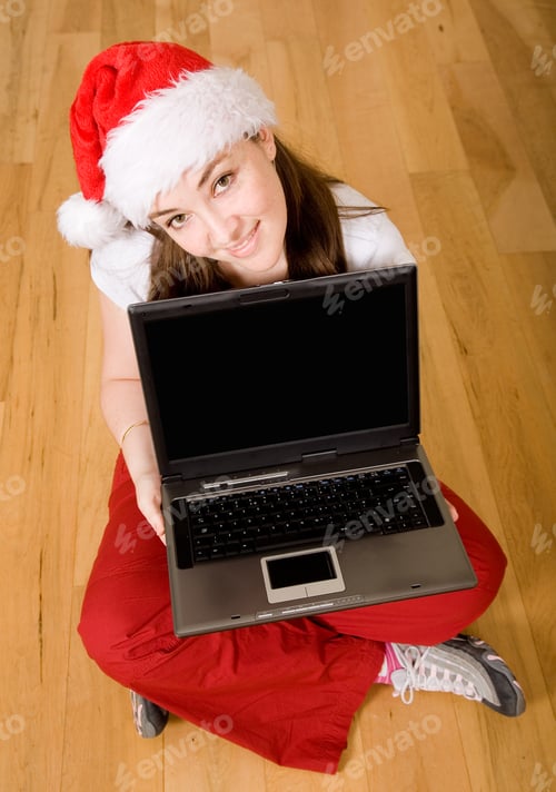 Preview: Christmas Online Shopping - Female Santa With A Laptop