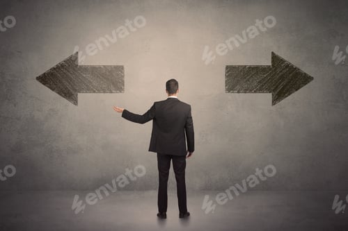 Preview: Business Man Taking A Decision While Standing In Front Of Two Grungy Arrows On Wall Concept