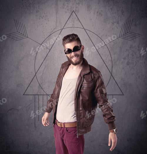 Preview: A Young Hipster Male In Modern Clothes Standing In Front Of An Urban Wall With Modern Sign