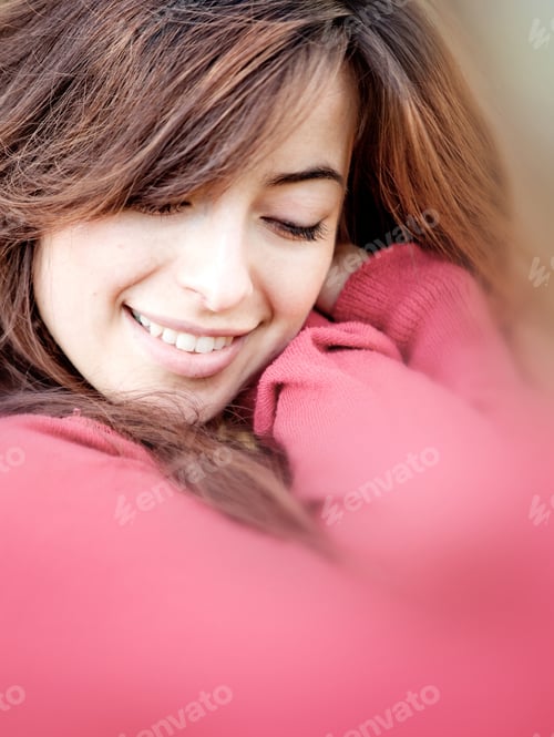 Preview: Portrait Of A Beautiful Young Woman Cuddling And Smiling