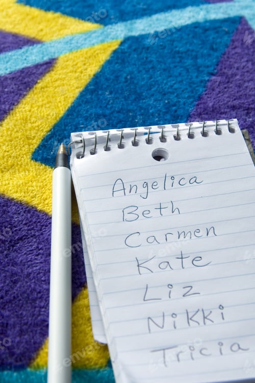 Preview: List Of Female Names On Pocket Notebook On Beach Towel