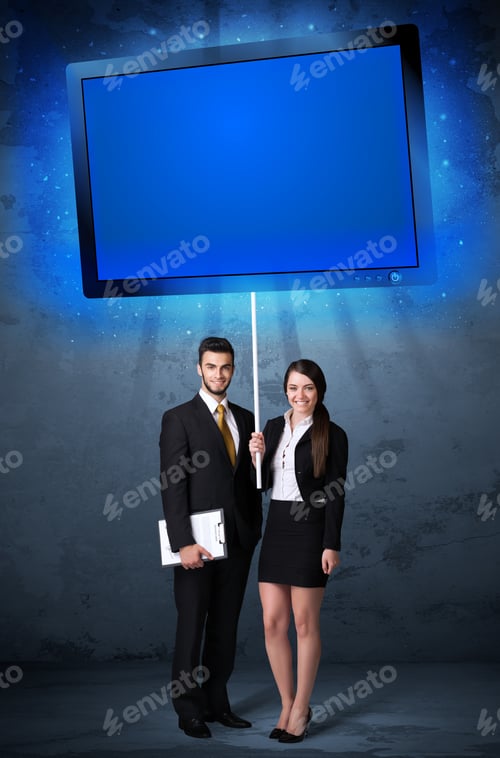 Preview: Young Business Couple Holding A Big, Blue Shining Tablet