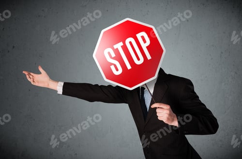 Preview: Businessman Standing And Holding A Stop Sign In Front Of His Head