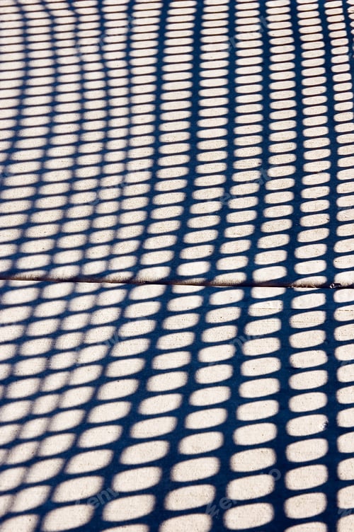 Preview: Shadows Of Temporary Plastic Fence On Sidewalk