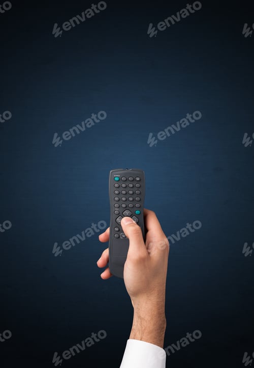 Preview: Hand Holding A Remote Control On Blue Background