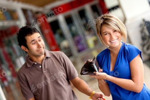 Preview: Woman Displaying Her Man'S Empty Wallet At A Shopping Center