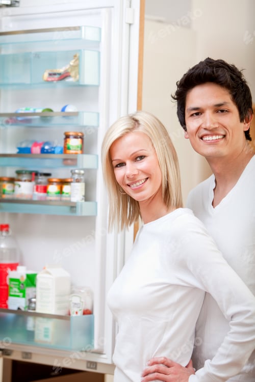 Preview: Couple At Home Looking Inside The Fridge And Smiling