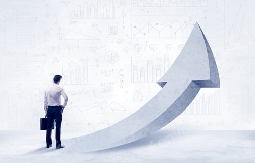 Preview: Young Sales Business Person In Elegant Suit Standing With His Back In Front Of A Big Arrow Pointing