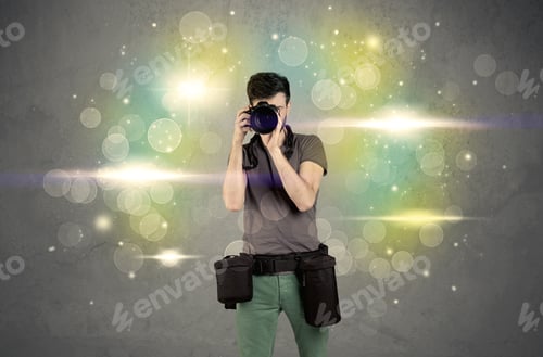 Preview: A Young Amateur Photographer With Professional Camera Equipment Taking Picture In Front Of Grey