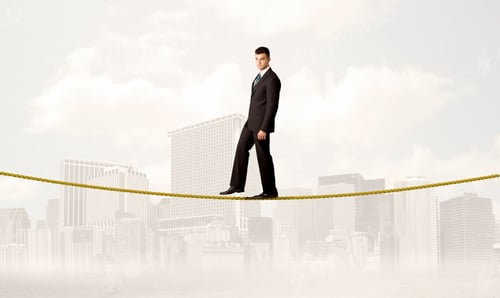 Preview: A Young Elegant Businessman Walking On Tight Golden Rope In Front Of City Buildings Landscape