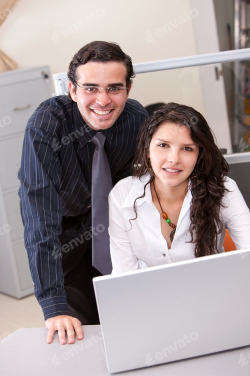Preview: Business Couple Smiling On A Laptop In An Office