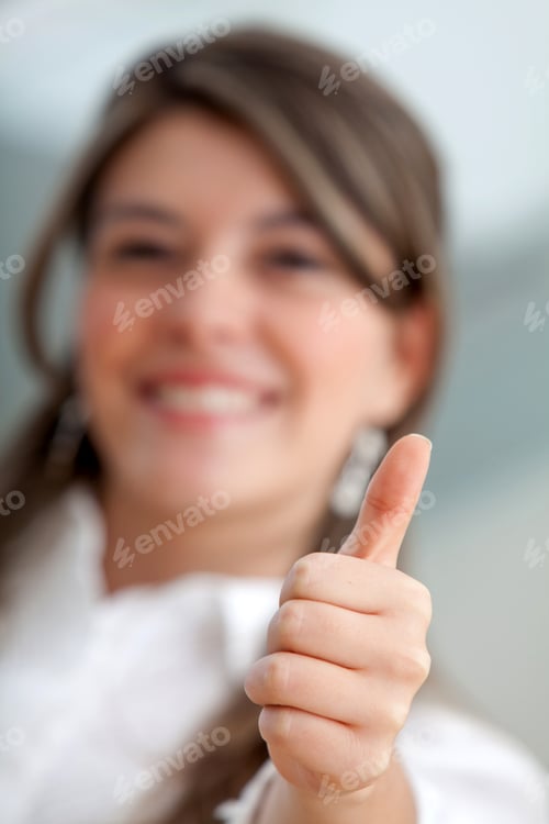 Preview: Friendly Business Woman Smiling With Thumb Up - Focus On Hand