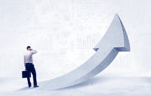 Preview: Young Sales Business Person In Elegant Suit Standing With His Back In Front Of A Big Arrow Pointing