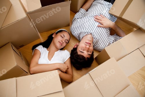 Preview: Couple Tired Of Packing Lying On The Floor With Boxes And Sleeping
