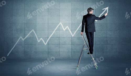 Preview: A Businessman In Modern Stylish Elegant Suit Standing On A Small Ladder And Drawing Pie And Block