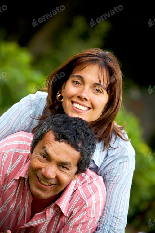 Preview: Happy Couple In Their Thirties Smiling And Lying On The Grass Outdoors