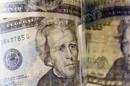 Preview: Close-Up Of U.S. $20 Bills In A Glass Bottle, With Reflection