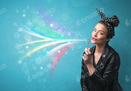 Preview: Beautiful Girl Blowing Abstract Colorful Bubbles And Lines On Blue Background