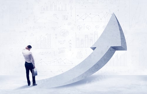 Preview: Young Sales Business Person In Elegant Suit Standing With His Back In Front Of A Big Arrow Pointing