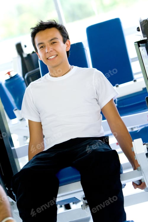 Preview: Young Man Smiling And Looking Happy At The Gym