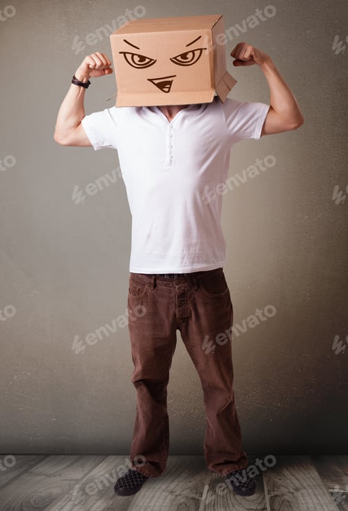 Preview: Young Man Standing And Gesturing With A Cardboard Box On His Head With Evil Face
