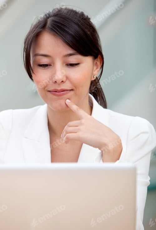 Preview: Thoughtful Business Woman Working On A Laptop