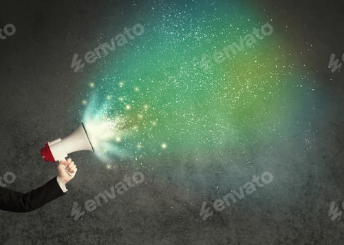Preview: Caucasian Business Hand Holding Megaphone With White Sparkles On A Grunge Background