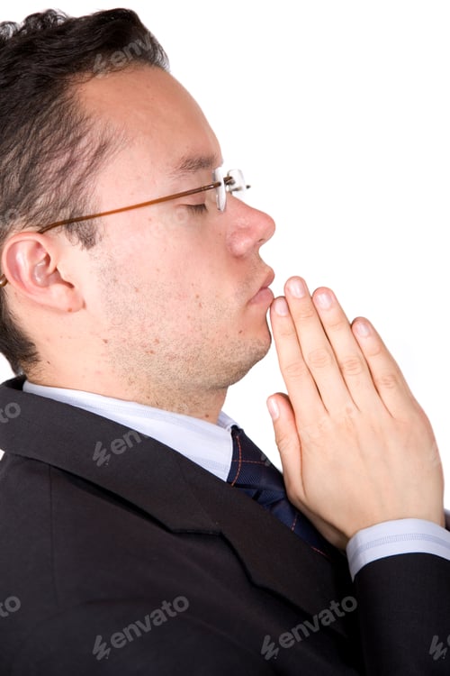 Preview: Business Man With Eyes Closed Doing A Prayer Over A White Background