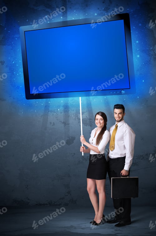 Preview: Young Business Couple Holding A Big, Blue Shining Tablet