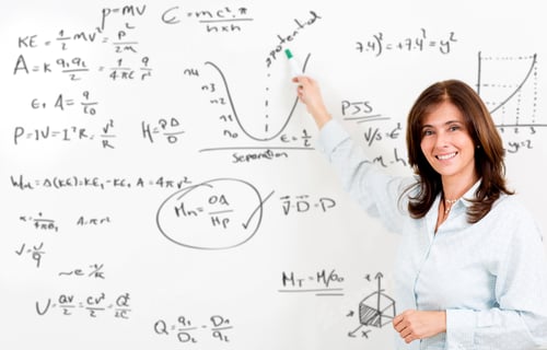 Preview: Maths Teacher Writing Fromulas On The Board And Smiling