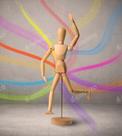 Preview: Wooden Mannequin Posed In Front Of A Greyish Background With Colorful Lines Behind It