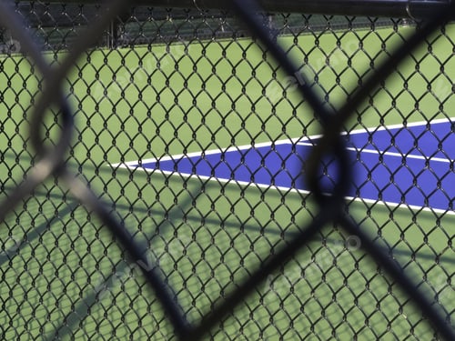 Preview: Vision Of Privilege: Corner Of Tennis Court Seen Through Two Wire Mesh Fences (Selective Focus)