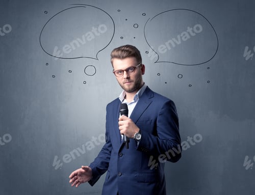 Preview: Businessman Speaking Into Microphone With Speech Bubbles Over His Head