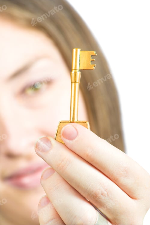 Preview: Woman Holding The Key Of Success In Focus Over A White Background