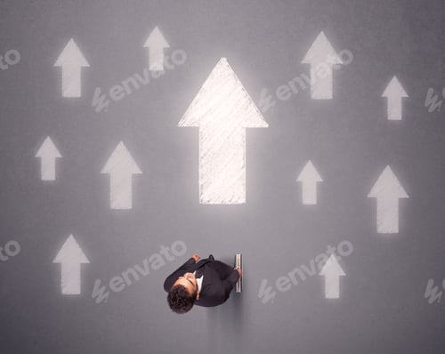 Preview: Young Contemplating Businessman Stands In Front Of White Arrows