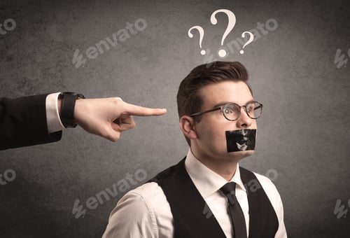 Preview: Caucasian Business Hand Pointing At Scared Employee With Big White Question Marks Above His Head
