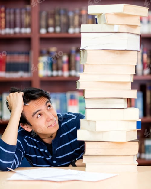 Preview: Overwhelmed Male Student With A Pile Of Books