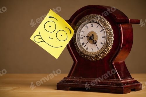 Preview: Drawn Smiley Face On A Post-It Note Sticked On An Alarm Clock