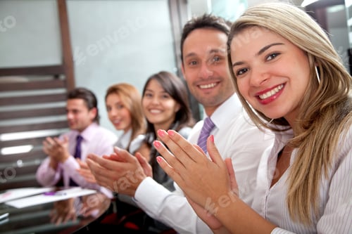Preview: Business Team Clapping In An Office Facing The Camera