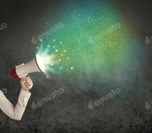 Preview: Caucasian Business Hand Holding Megaphone With White Sparkles On A Grunge Background