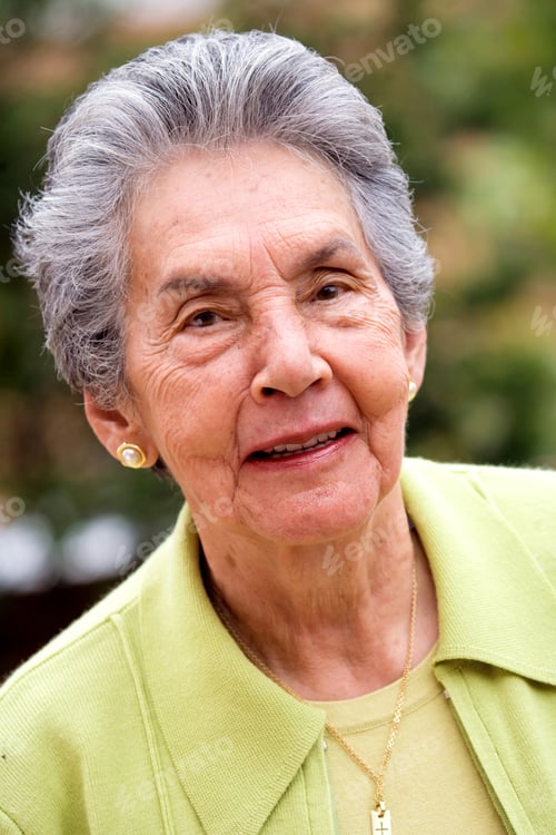 Preview: Happy Retired Woman Portrait Smiling Outdoors In Green Colours