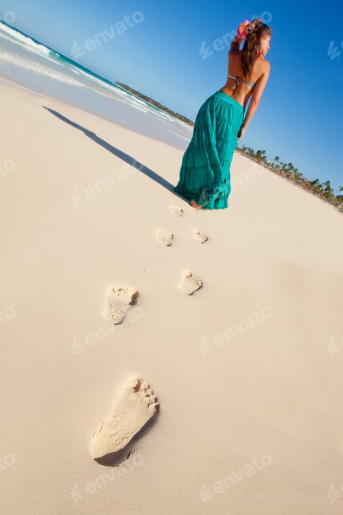 Preview: Hawaiian Woman Walking At The Beach Leaving Footprints On The Sand
