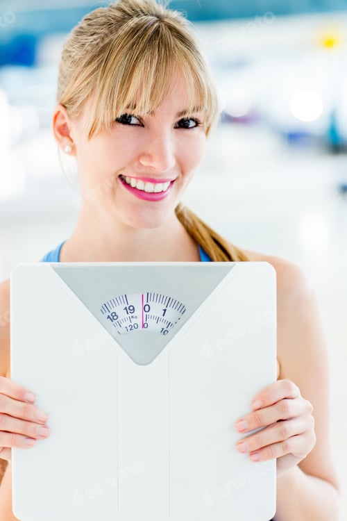 Preview: Beautiful Woman Loosing Weight And Holding A Scale
